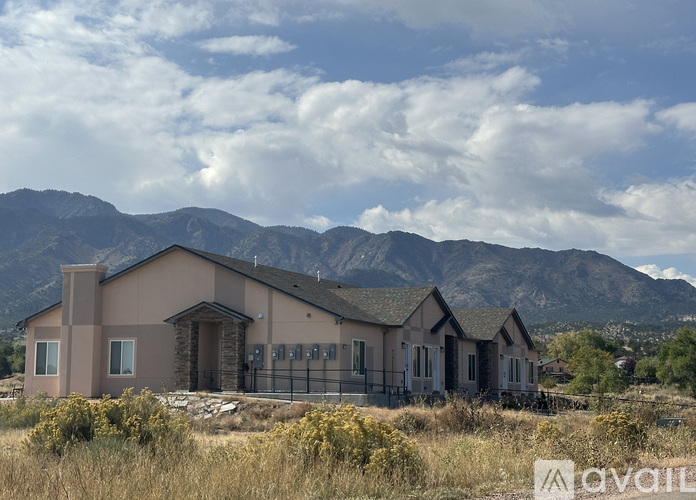 A house with a mountain in the background is for sale.
