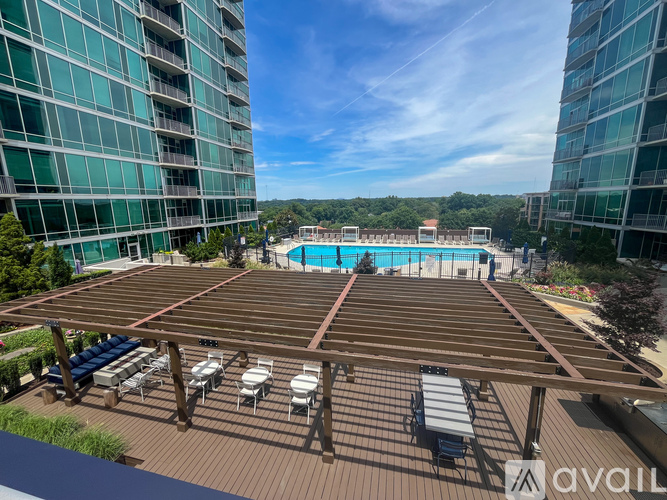 A rooftop with a pool and sun loungers.