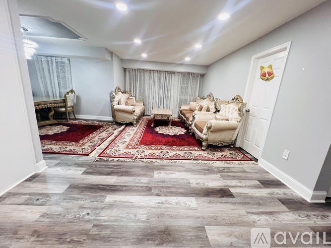 A living room with a rug and a sofa.