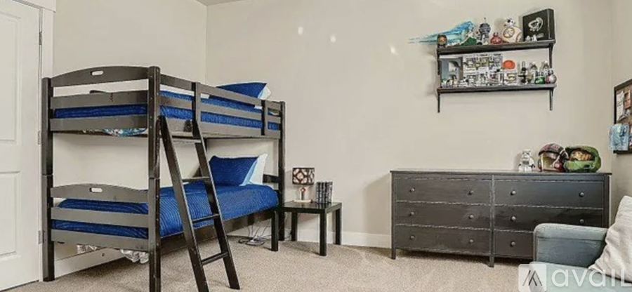 A room with bunk beds and a dresser.