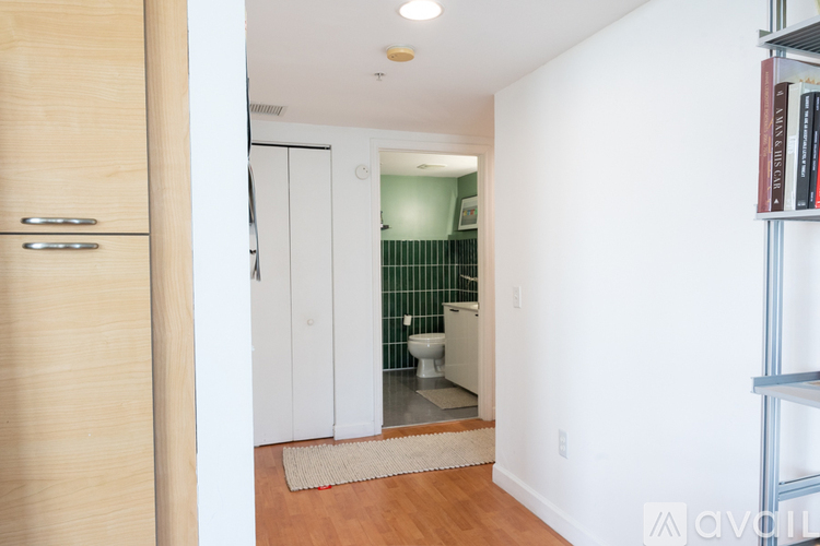 A bathroom with a toilet, sink, and a mirror.