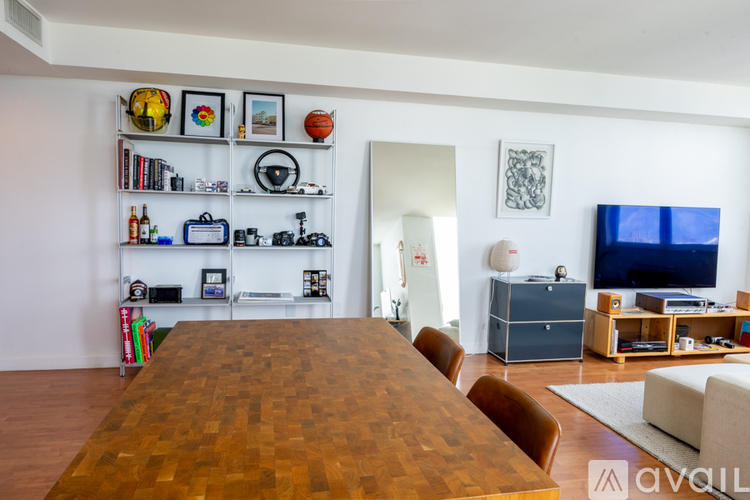A living room with a wooden table and chairs.
