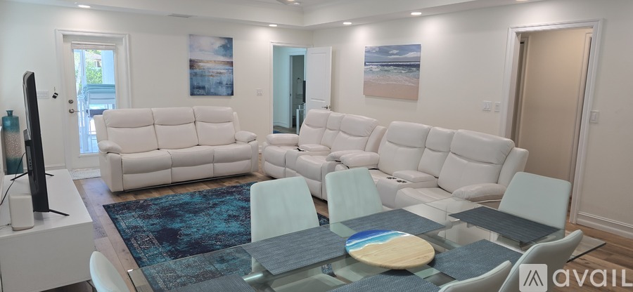 A living room with a large couch and a television.