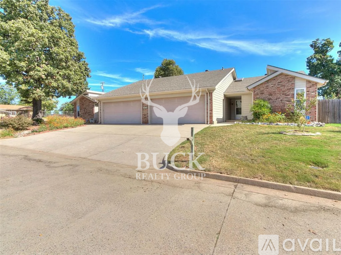 A house with a deer head logo on the garage door.