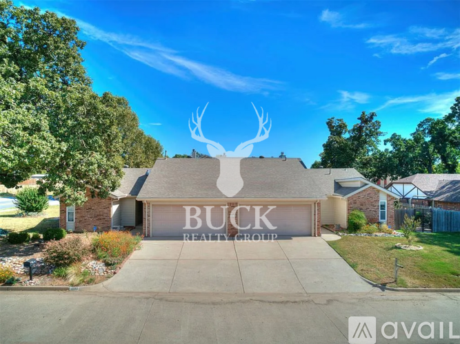 A real estate sign for Buck Realty Group is displayed in front of a house.