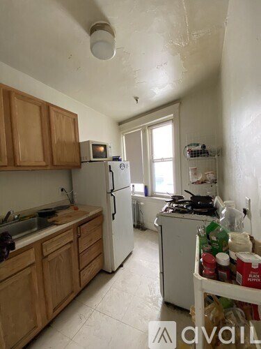A kitchen with wooden cabinets and a white fridge.