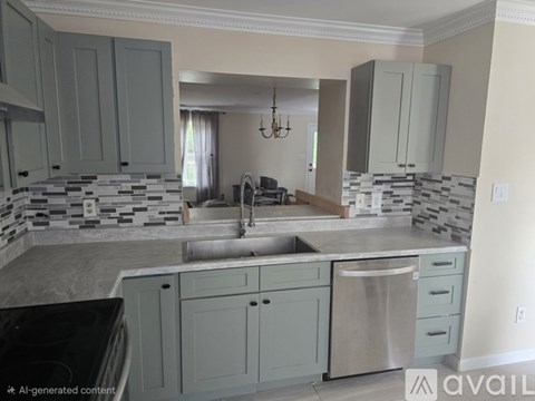 A kitchen with a black counter top and a sink.