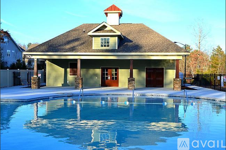 A house with a pool in front of it.