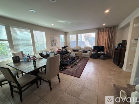 A living room with a dining table and chairs.
