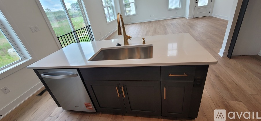 A kitchen with a sink and a window.
