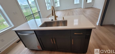 A kitchen with a sink and a window.