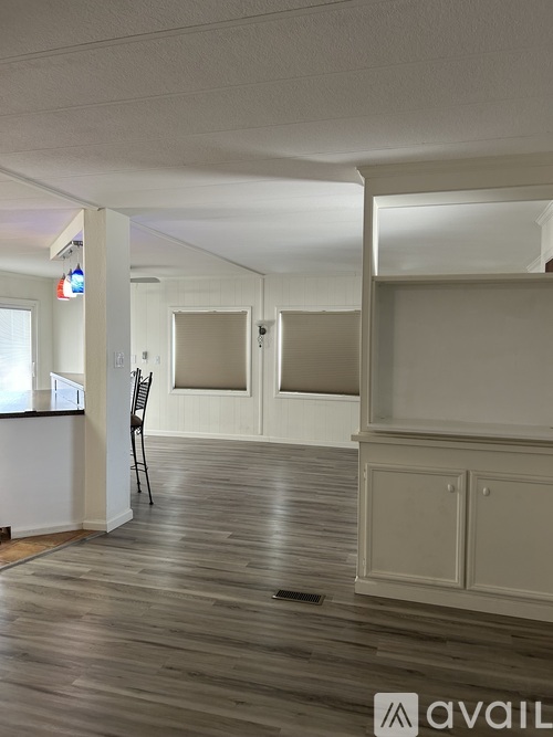 A room with wooden floors and white walls.