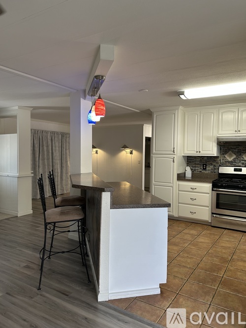 A kitchen with a bar stool and a counter.