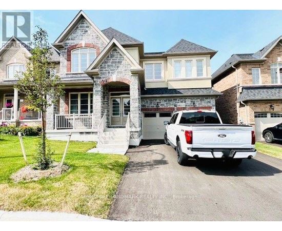 A white pickup truck is parked in front of a two-story house.