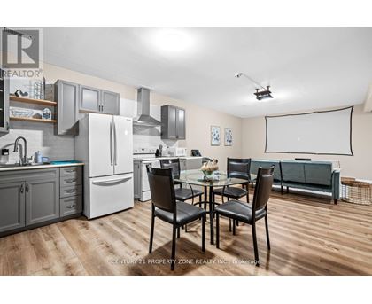 A kitchen with a dining table and chairs.