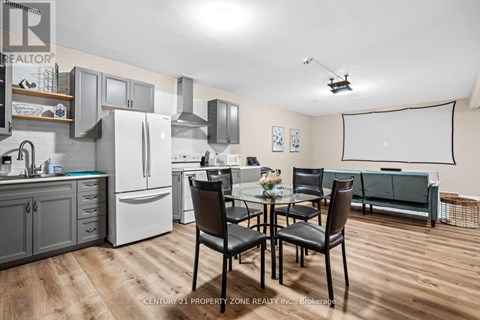 A kitchen with a dining table and chairs.