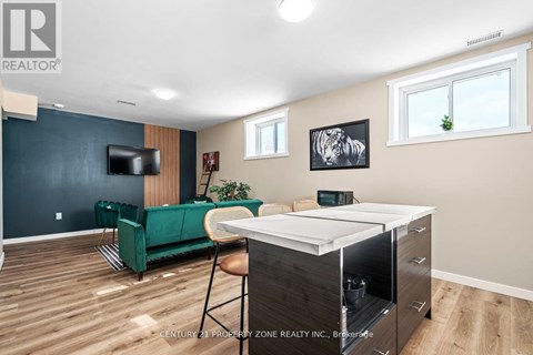 A living room with a green sofa and a television.