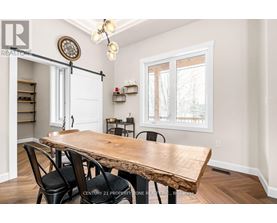 A dining room with a wooden table and chairs.
