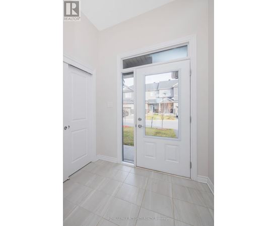 A white door with a glass window is in a room with white walls.