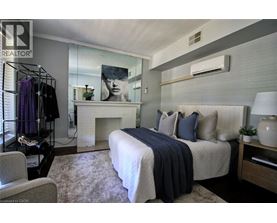 A bedroom with a large bed and a fireplace.