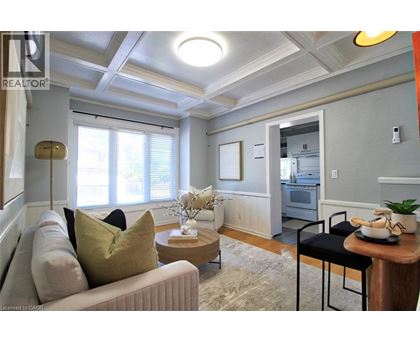 A living room with a couch, a coffee table, and a dining table.