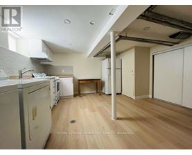 A kitchen with a dining table and a washing machine.