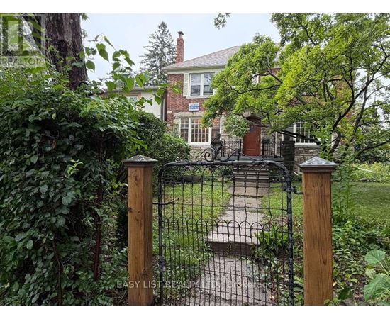 A black wrought iron gate with a wooden post on either side.