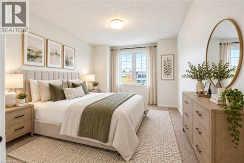 A bedroom with a large bed, a mirror, and a window with curtains.