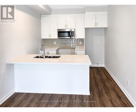 A kitchen with white cabinets and a white island.