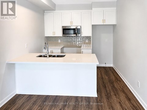 A kitchen with white cabinets and a white island.