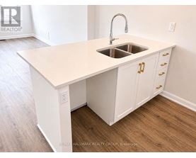 A kitchen island with a sink and cabinets.