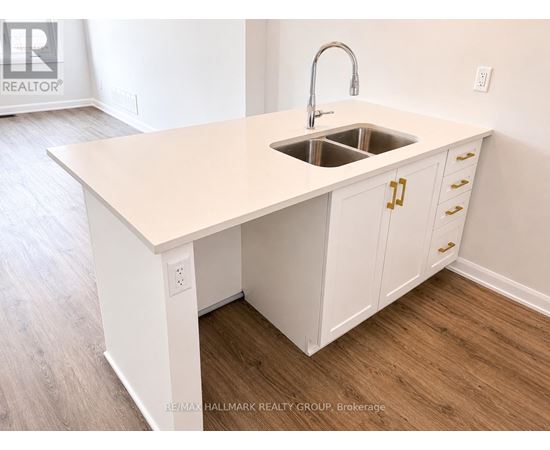 A kitchen island with a sink and cabinets.