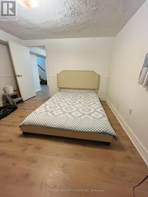 A bedroom with a bed and a window.