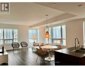 A modern kitchen with a dining table and chairs.