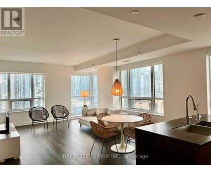 A modern kitchen with a dining table and chairs.