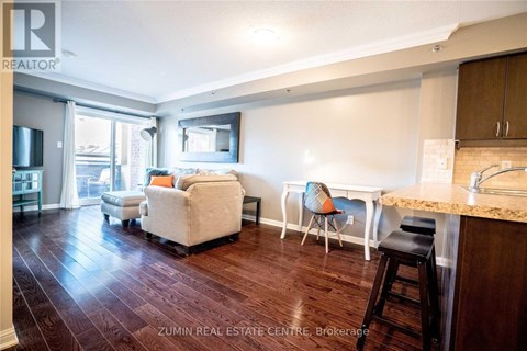 A living room with a white couch and a wooden floor.