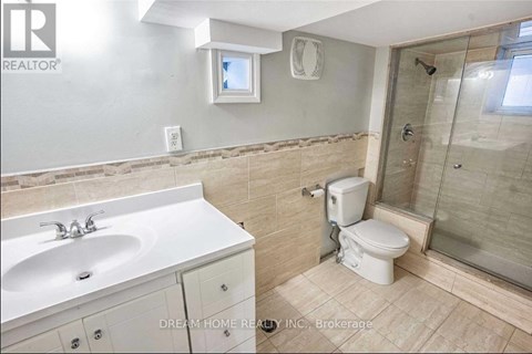 A bathroom with a sink, toilet, and shower.