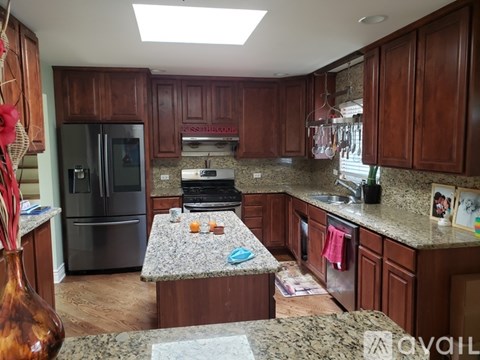 A kitchen with wooden cabinets and granite countertops.