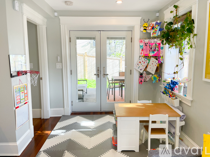 A white kitchen with a wooden table and chairs.
