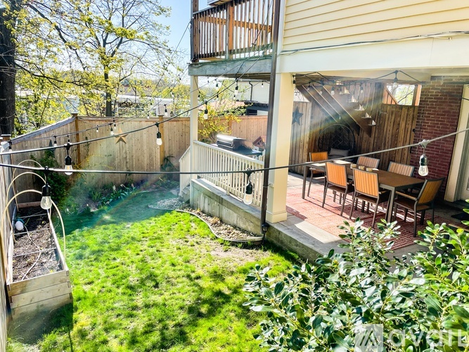A backyard with a deck and a hot tub.