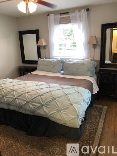A bedroom with two beds and a ceiling fan.