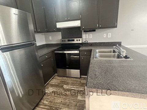 A kitchen with a stainless steel refrigerator and a sink.