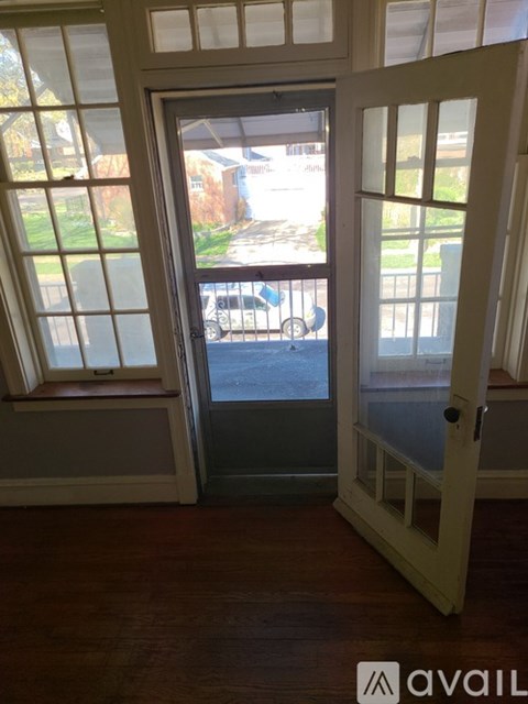 A white door with a glass window is open.