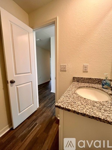 A bathroom with a sink and a door.