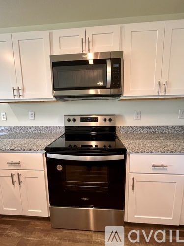 A kitchen with a stove top oven and microwave above it.
