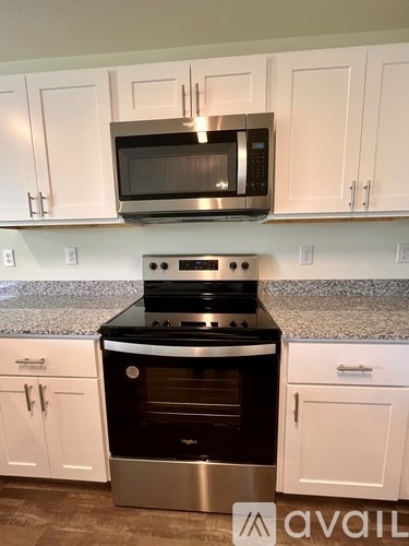 A kitchen with a stove top oven and microwave above it.