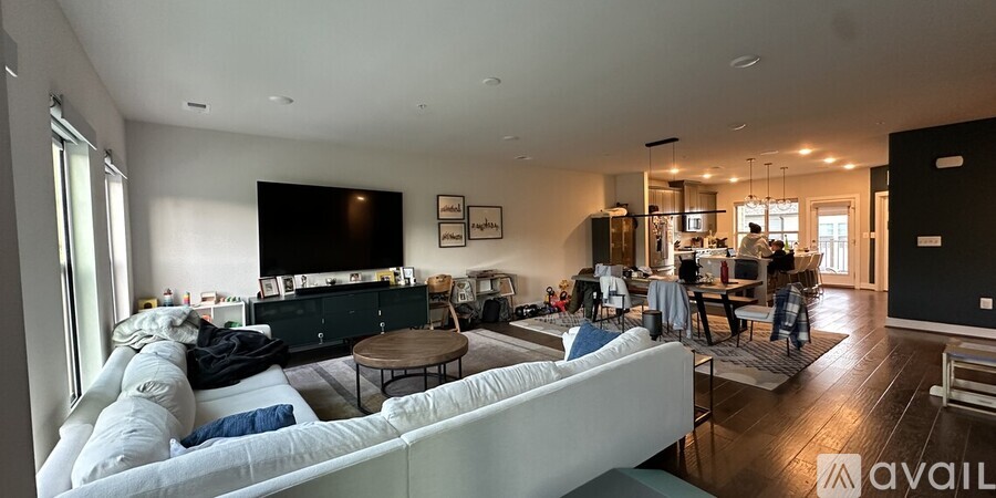 A living room with a white couch and a television.