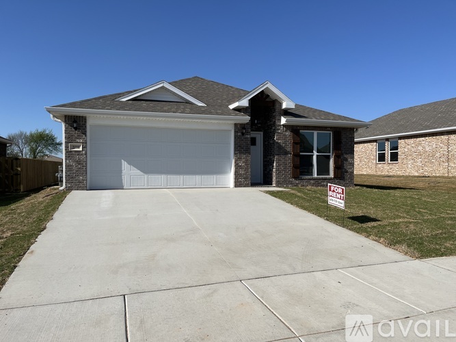 A house with a garage is for sale.