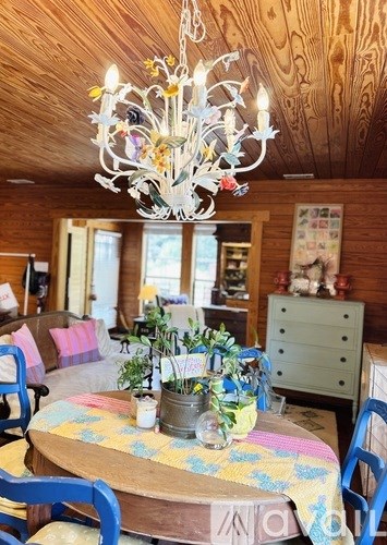 A dining room with a round table and blue chairs.