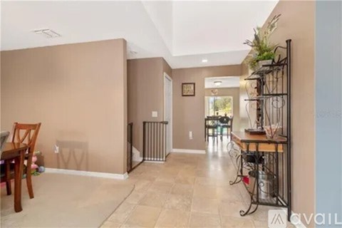 A living room with a dining table and chairs.